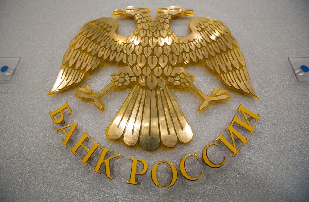 The seal of the Russian Central bank, also known as Bank Rossii, sits on display in Moscow, Russia, on Friday, March 13, 2015. Russia's central bank lowered its main interest rate in line with most economist forecasts, as stabilizing inflation clears the path to boosting an economy buckling under low oil prices and sanctions over Ukraine. Photographer: Andrey Rudakov/Bloomberg