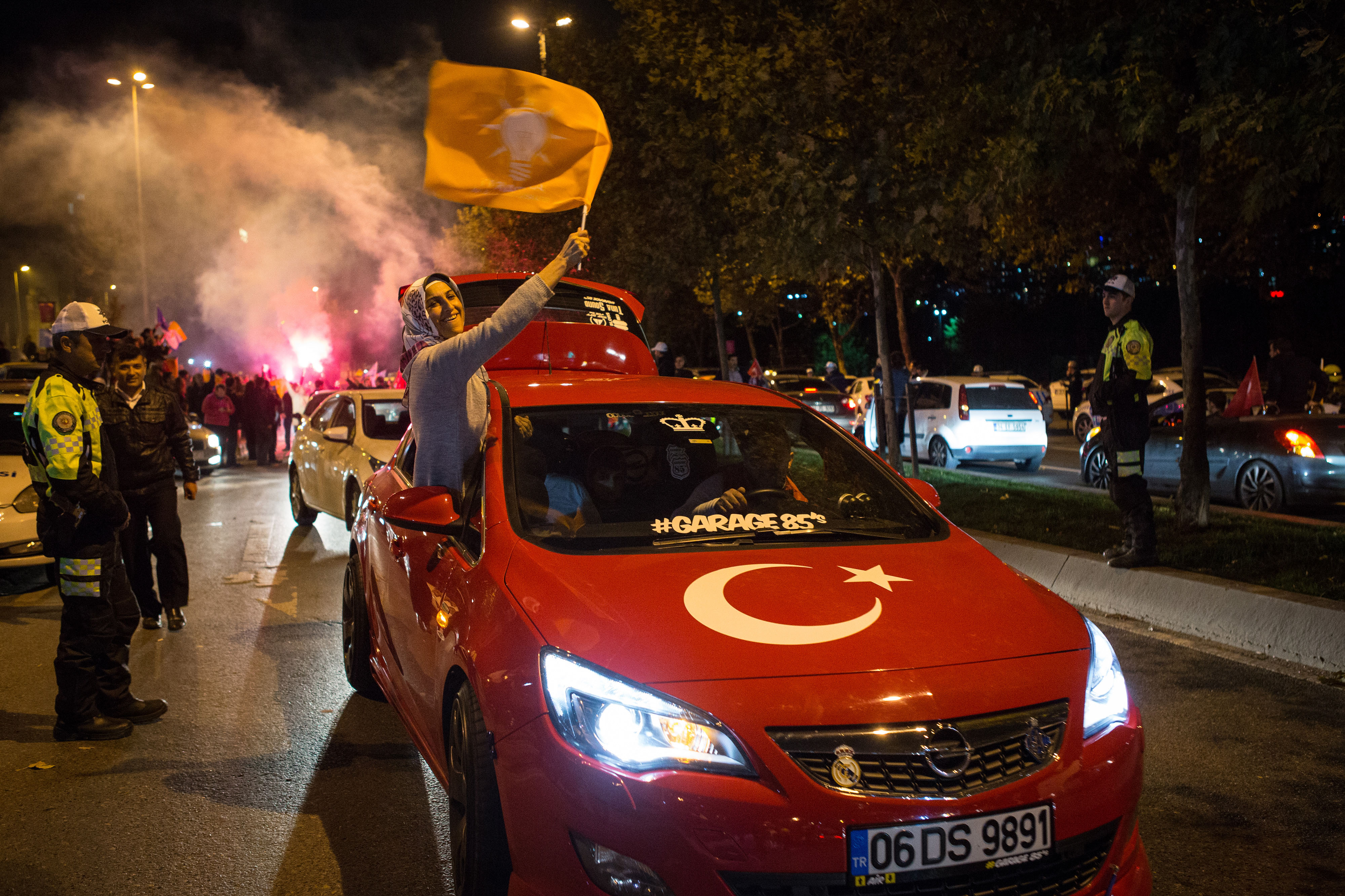 Supporters of the Justice and Development Party, also known as AK Party or AKP, celebrate following the result of the Turkish general election in Istanbul, Turkey, on Sunday, Nov. 1, 2015. Turkeys AK Party swept back into office in parliamentary elections, strengthening President Recep Tayyip Erdogans 13-year grip on power after a divisive campaign scarred by violence. Photographer: Kerem Uzel/Bloomberg
