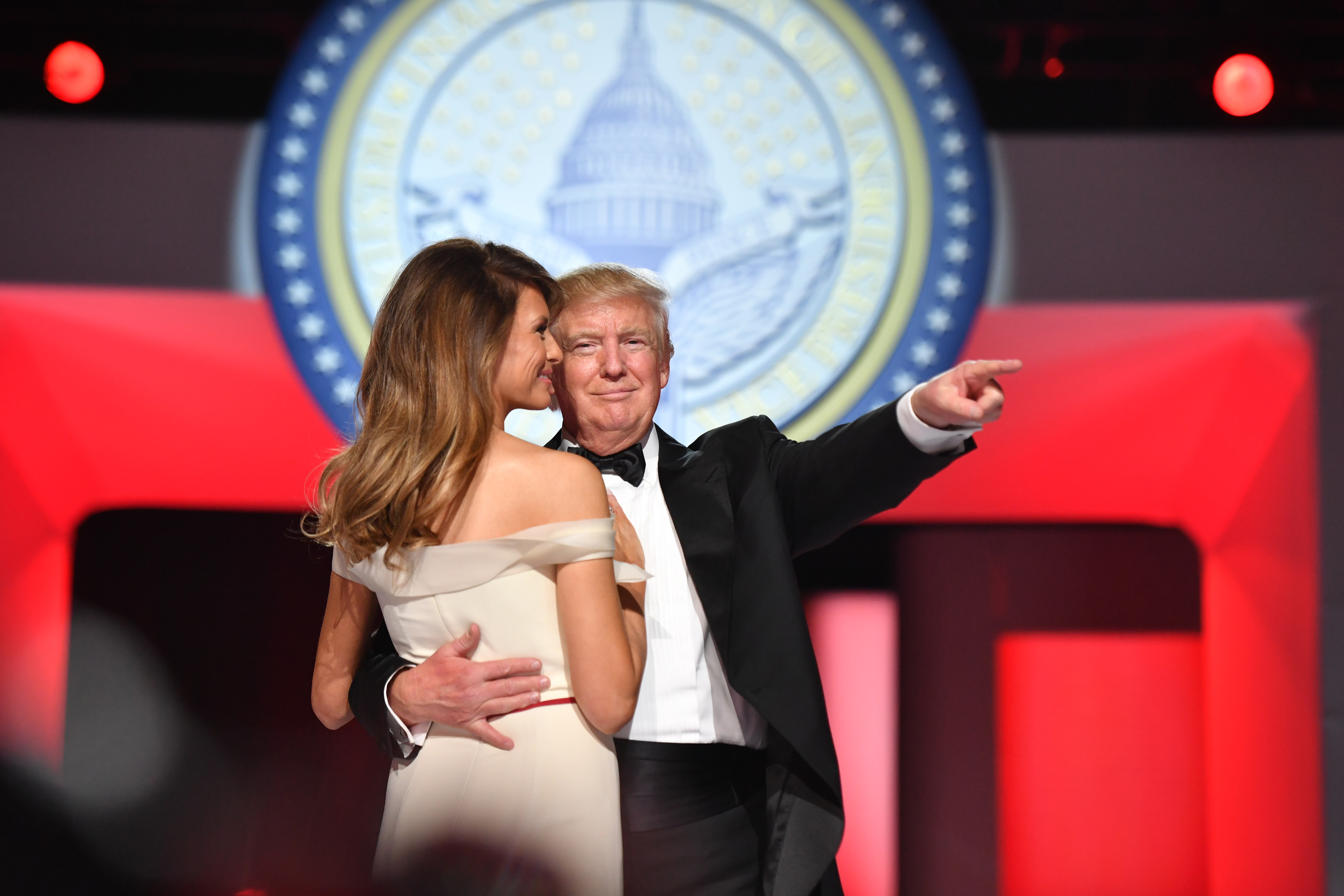 U.S. President Donald Trump, right, gestures as he dances with First Lady Melania Trump during the Freedom Ball in Washington, D.C., on Friday, Jan. 20, 2017. Senate Democrats and Republicans are tussling over how many of Trump's nominees can be confirmed on his first day in office, with Republicans threatening to work through the weekend to break the logjam. Photographer: Kevin Dietsch/Pool via Bloomberg