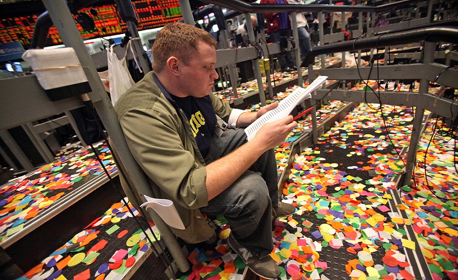 A trader still works after confetti had dropped upon the trading floor of Eurodollar Options during the last day of trading at the CME Group's Chicago Board of Trade in Chicago, Illinois, U.S., on Friday, Dec. 31, 2010. Photographer: Tim Boyle/Bloomberg *** Local Caption ***