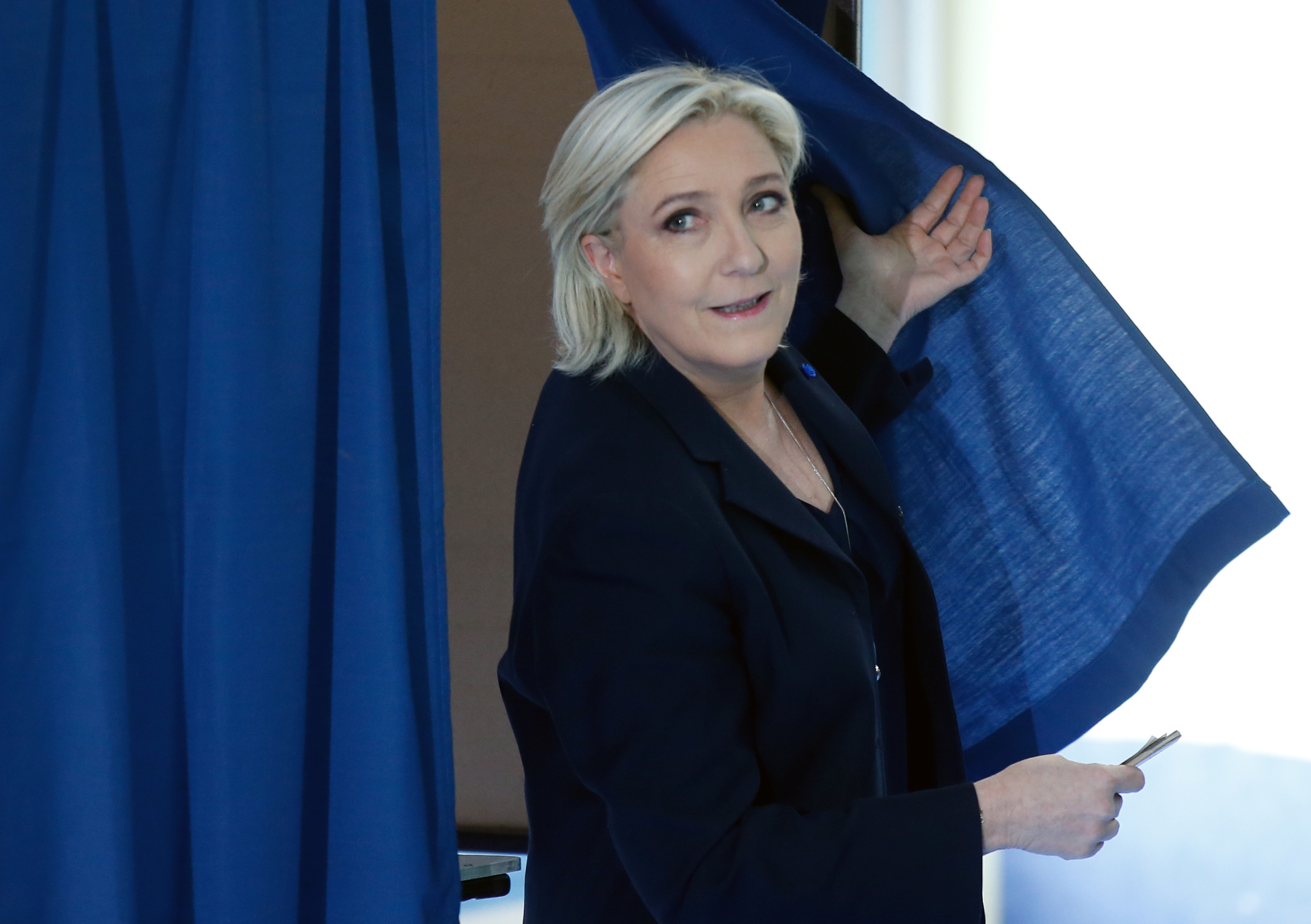 Marine Le Pen, French National Front (FN) political party leader and candidate for French 2017 presidential election, leaves a polling booth as she votes in the first round of 2017 French presidential election at a polling station in Henin-Beaumont, northern France, April 23, 2017. REUTERS/Pascal Rossignol - RTS13I5Z