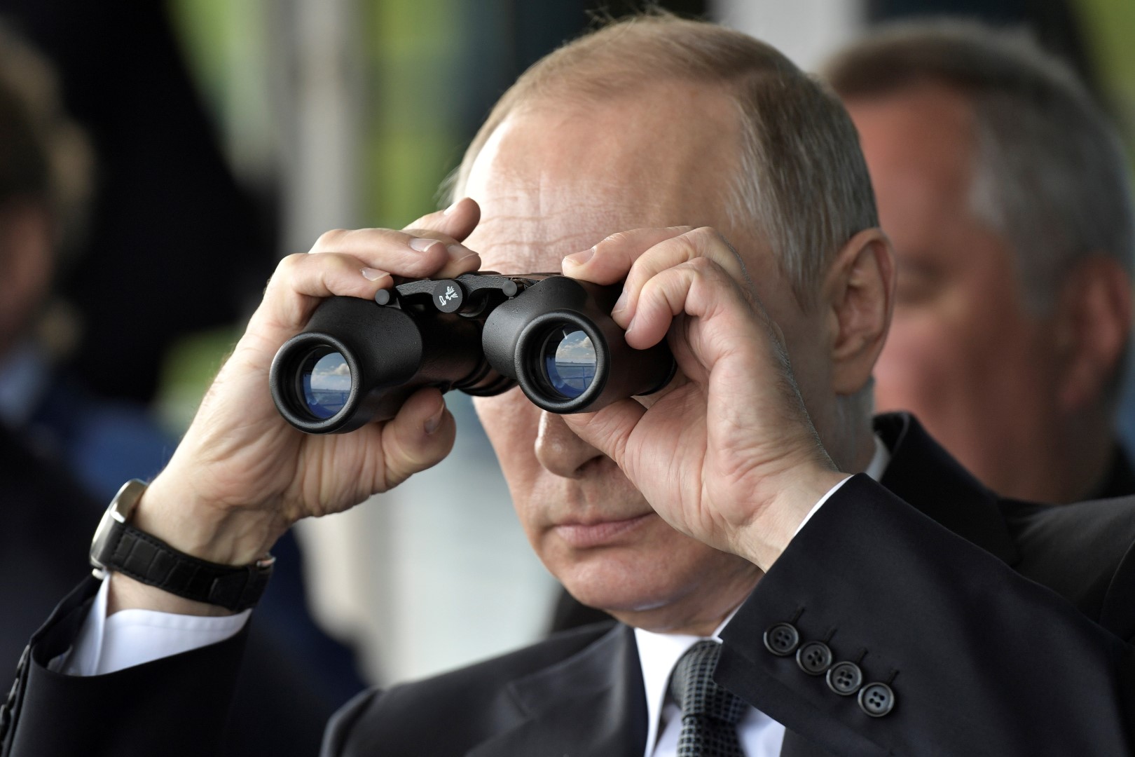 Russian President Vladimir Putin uses a pair of binoculars as he watches a display during the MAKS 2017 air show in Zhukovsky, outside Moscow, Russia July 18, 2017. Sputnik/Alexei Nikolsky/Kremlin via REUTERS ATTENTION EDITORS - THIS IMAGE WAS PROVIDED BY A THIRD PARTY. TPX IMAGES OF THE DAY - RTX3BX3L